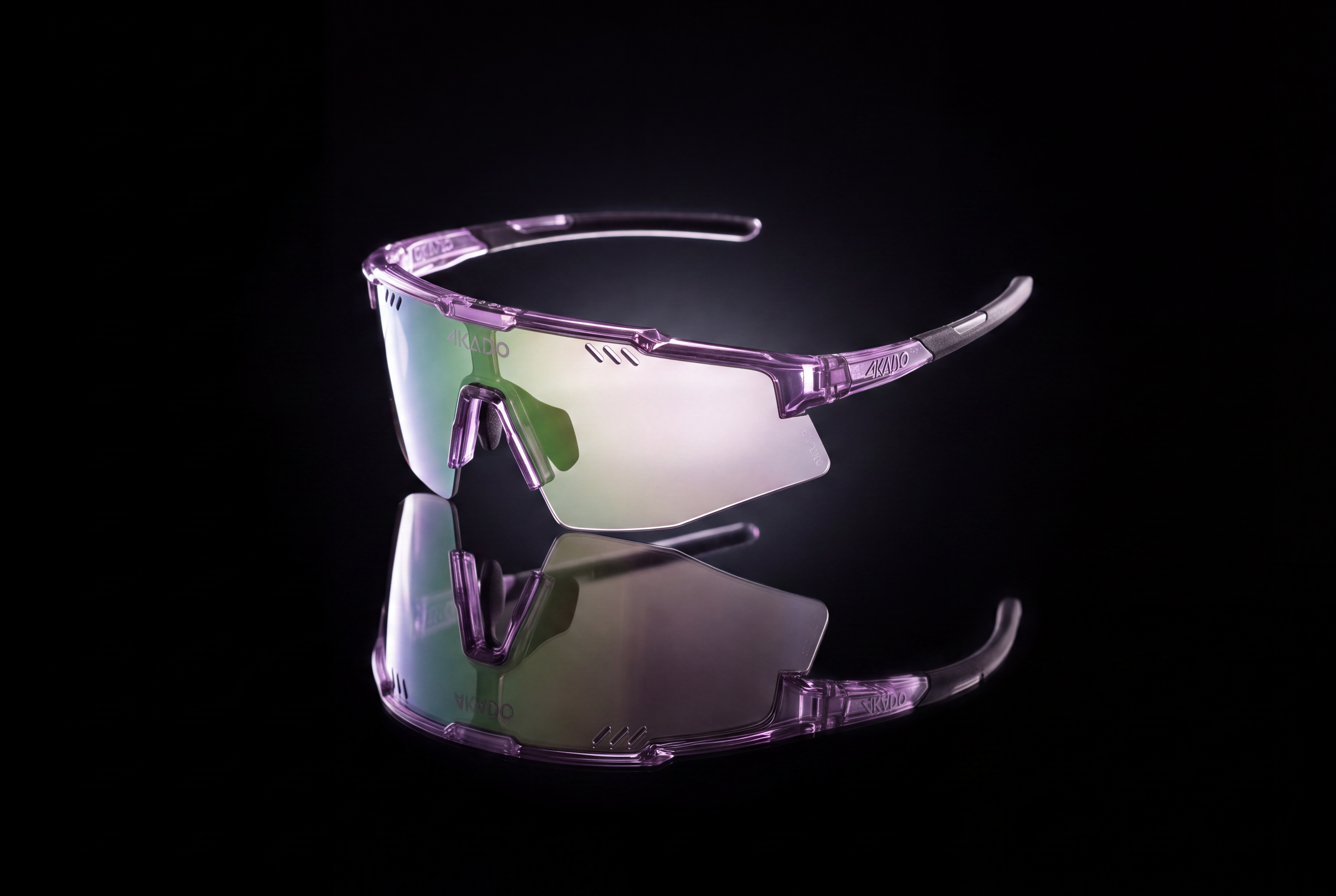 Sport sunglasses with a translucent purple frame and mirrored green-tinted lenses, displayed on a reflective black surface against a dark background.