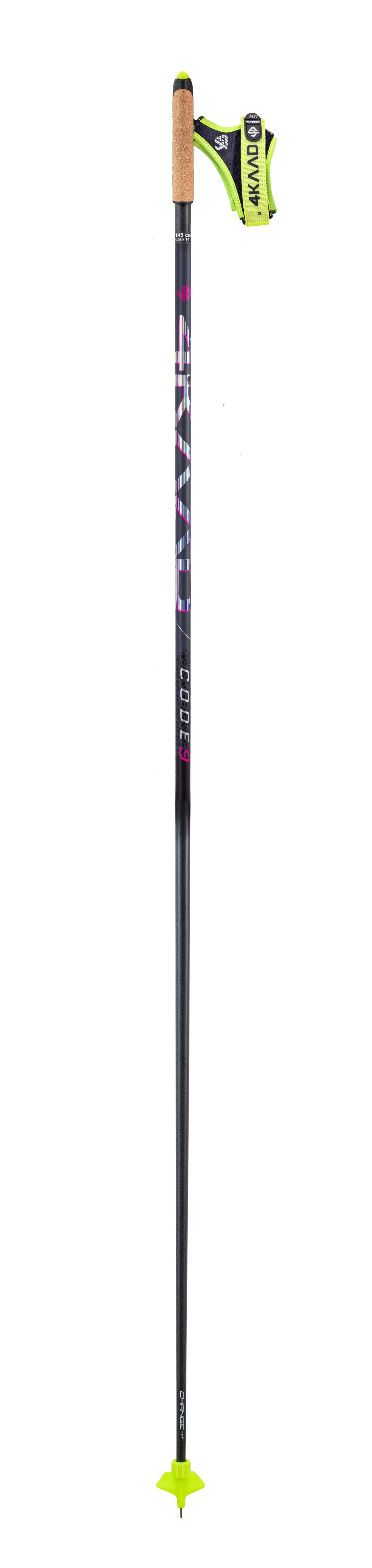 A single ski touring pole shown vertically against a plain white background. The pole is predominantly black with purple and white graphics, a light tan grip, a bright yellow-green adjustable buckle, and a matching yellow-green tip.