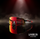 Sunglasses with red reflective lenses on a dark background with smoke, featuring 'La Vuelta' branding.