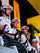 A group of professional cyclists wearing white team jerseys with red and blue graphics, white helmets, and colorful sunglasses, riding bicycles in a bright cycling team environment. 4kaad sports glasses used by every rider at tour de france