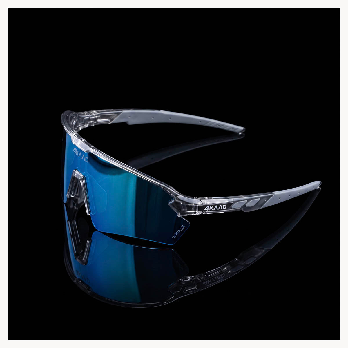 4KAAD shield-style sports sunglasses with a clear wraparound frame and a blue mirrored lens, shown on a black reflective background.